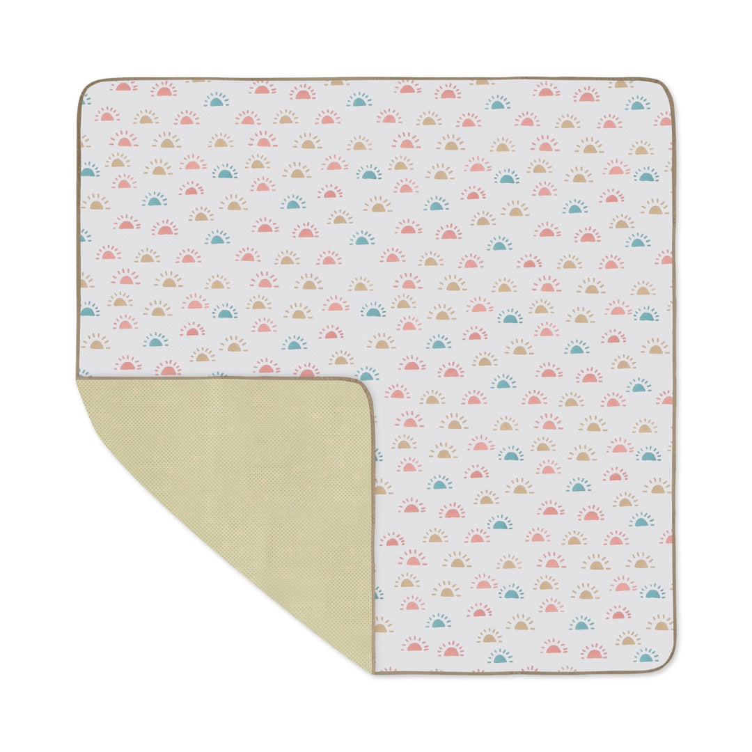 Patterned baby blanket as a water resistant splat mat floor cover for easy cleaning