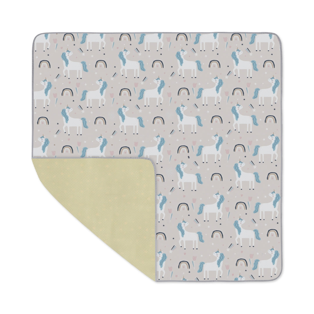 Unicorn-patterned baby blanket on Splat Mat Messy Floor Cover, water resistant floor cover
