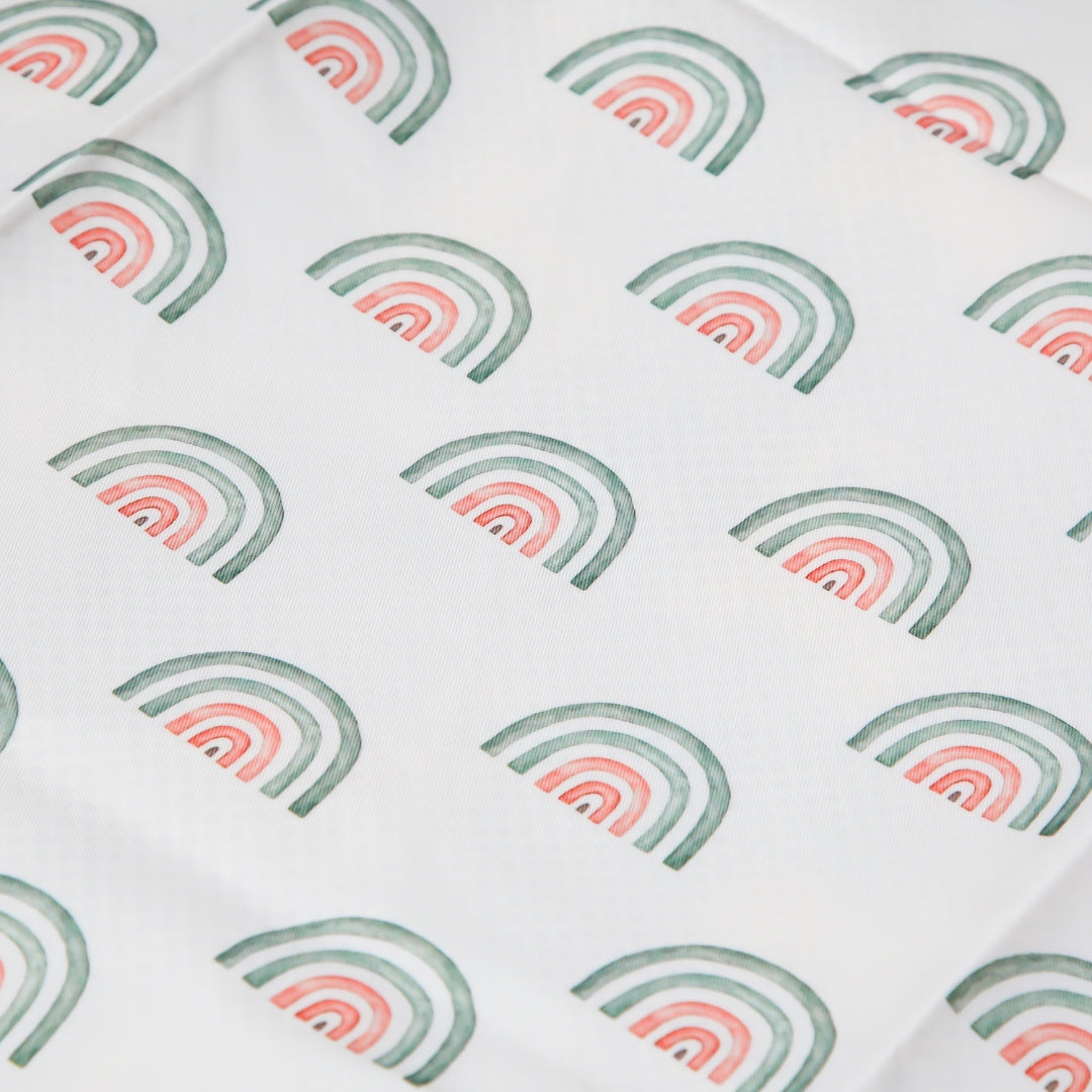 Water resistant fabric with rainbow pattern used as a Splat Mat Messy Floor Cover