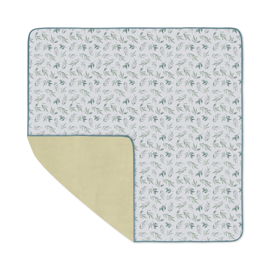 Patterned picnic blanket as a water resistant splat mat floor cover for kids
