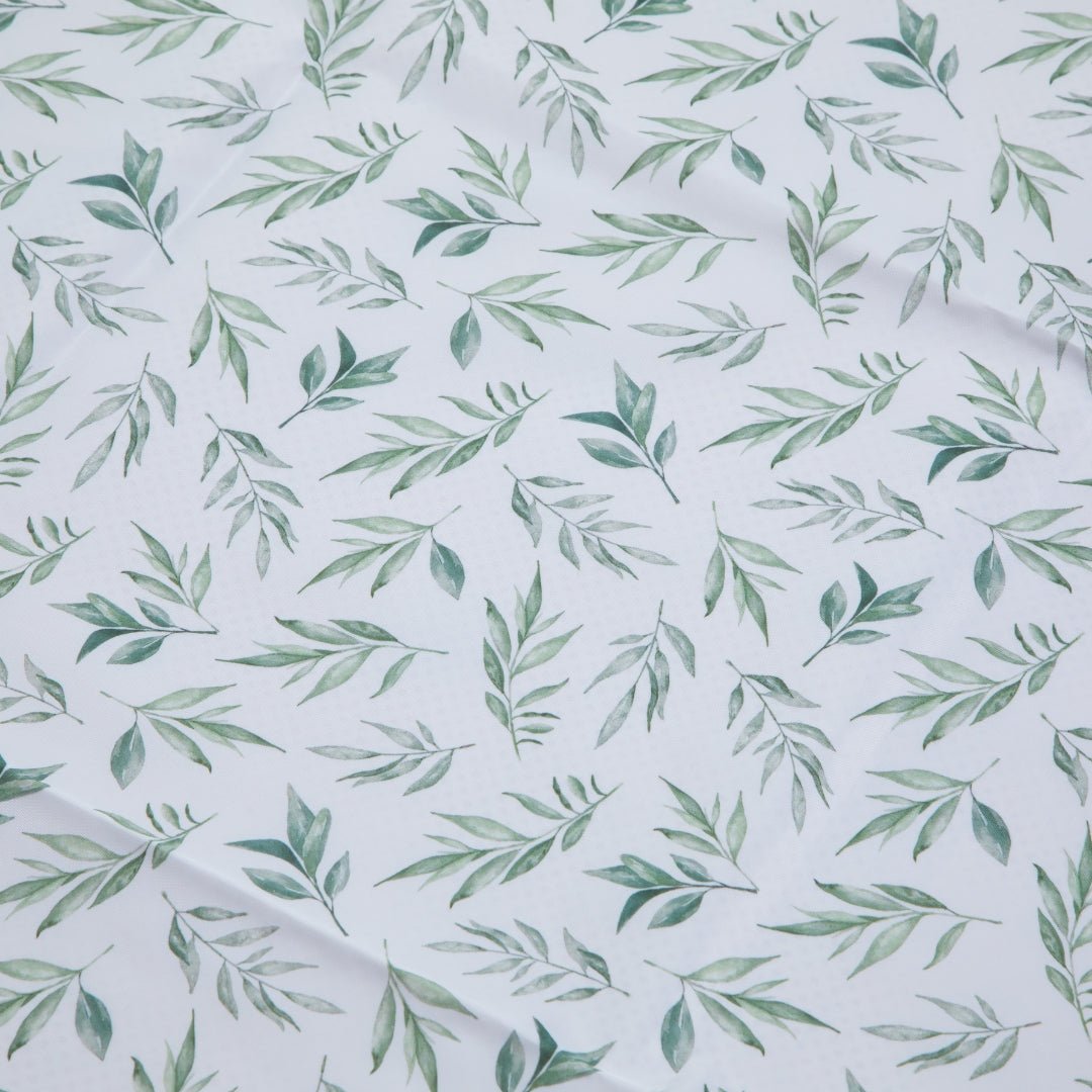 Green leaf pattern on water resistant splat mat floor cover for messy play